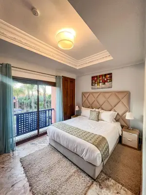 a bedroom with a large bed and a balcony at Villa Premium Marrakech in Marrakech