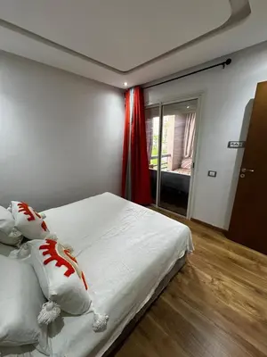 a bedroom with a bed with white sheets and pillows at Garden level & pool, cozy apartment queen size bed in Marrakech