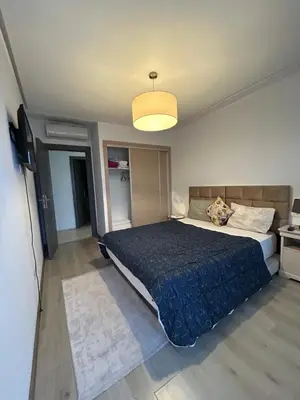 a bedroom with a bed with a blue comforter at Said in Marrakech