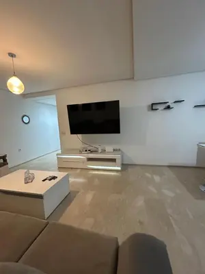 a living room with a couch and a flat screen tv at Said in Marrakech
