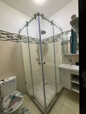 a bathroom with a shower and a toilet and a sink at Joyau Moderne Appartement in Marrakech