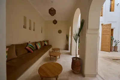 a living room with a couch and a table at Riad Al Muhandiz Peaceful Duplex Suites near Jemaa El Fna in Marrakech