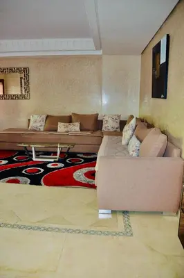 a living room with a couch and a table at Appartement Ihssane Plaza Kech in Marrakech