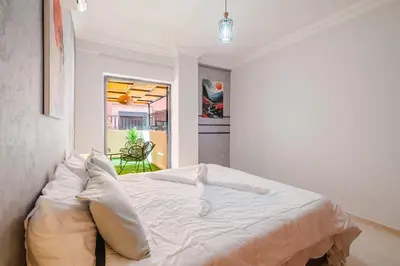 a white bed in a room with a window at apartment gilez in Marrakech