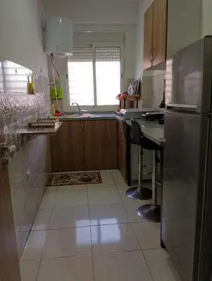 a kitchen with a stainless steel refrigerator and a counter at Appartement meublé à louer à Marrakech in Marrakech