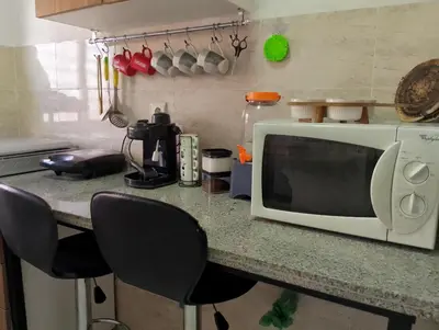 a microwave sitting on a counter in a kitchen at Appartement meublé à louer à Marrakech in Marrakech