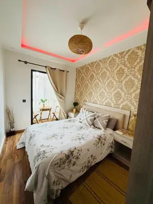 a bedroom with a white bed and a pink light at Marrakech Soft Escape in Marrakech