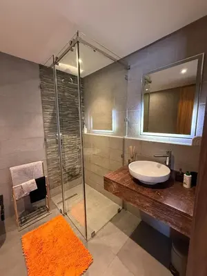 a bathroom with a sink and a glass shower at Marrakech Palm View in Marrakech