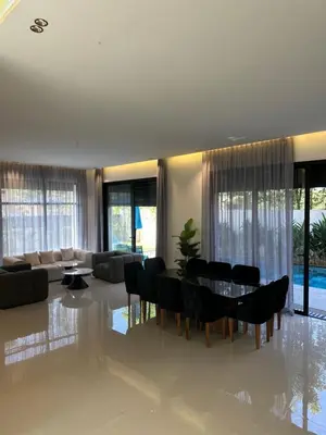 a living room with a table and chairs at Villa Tiffany NORIA GOLF in Marrakech