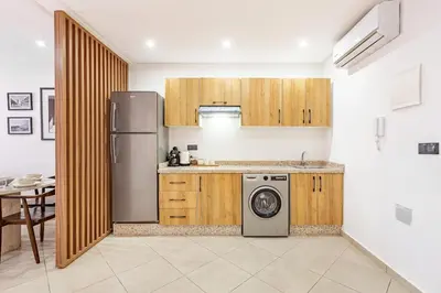 a kitchen with a refrigerator and a washing machine at Modern & cozy apartment in Marrakech