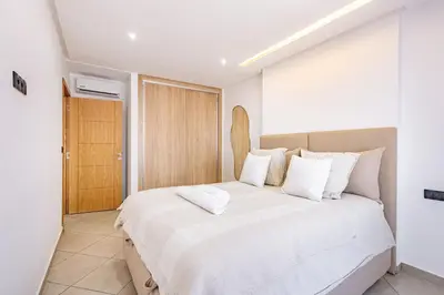 a bedroom with a large white bed with white pillows at Modern & cozy apartment in Marrakech