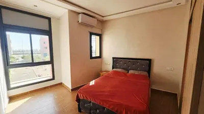 a bedroom with a bed and a large window at Villa with private pool in Marrakech