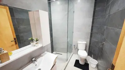 a bathroom with a shower and a toilet and a sink at Villa with private pool in Marrakech