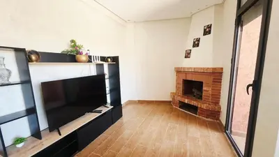 a living room with a large television and a fireplace at Villa with private pool in Marrakech