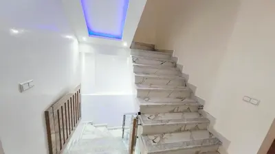 a staircase in a house with a blue window at Villa with private pool in Marrakech