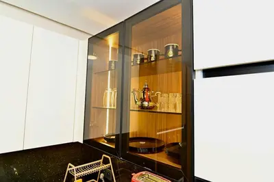 a kitchen with glass cabinets and a shelf with dishes at Luxurious colorful apartment in Marrakech
