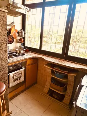 a kitchen with a stove and a oven with windows at Air Conditioned Appartment across YSL Museum in Marrakech