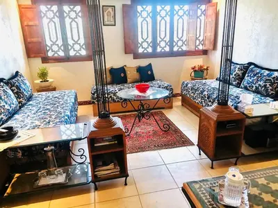a living room with two couches and a table at Air Conditioned Appartment across YSL Museum in Marrakech