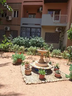 a fountain in front of a building with potted plants at Air Conditioned Appartment across YSL Museum in Marrakech