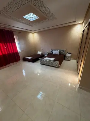 a large room with two beds and a couch at Villa avec piscine privé in Marrakech
