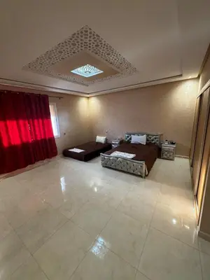 a large room with two beds and a couch at Villa avec piscine privé in Marrakech