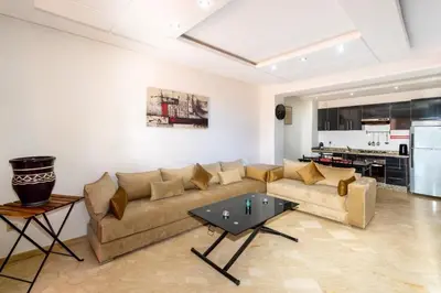 a living room with a couch and a table at La Perle - Semlalia Gueliz - 2 Prs - Balcony in Marrakech