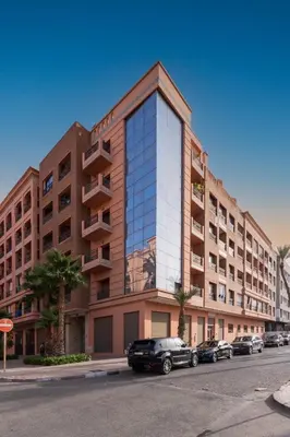 a large building with cars parked in front of it at La Perle - Semlalia Gueliz - 2 Prs - Balcony in Marrakech