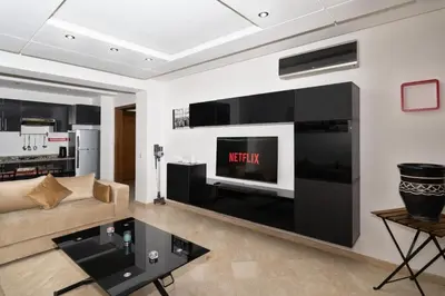 a living room with a couch and a tv at La Perle - Semlalia Gueliz - 2 Prs - Balcony in Marrakech