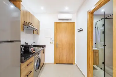 a kitchen with a sink and a washer at Appartement chic près de la gare in Marrakech