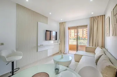 a living room with a couch and a tv at Appartement chic près de la gare in Marrakech