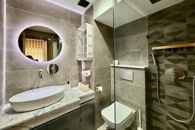 a bathroom with a sink and a toilet and a mirror at Two Bedroom Apartment with Pool in Marrakech