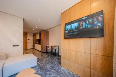 a living room with a flat screen tv on a wall at appartement Confort & modernité au centre de Marrakech in Marrakech