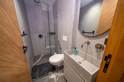 a bathroom with a toilet and a sink and a mirror at appartement Confort & modernité au centre de Marrakech in Marrakech