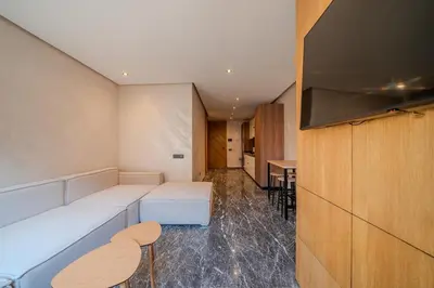 a living room with a couch and a tv at appartement Confort & modernité au centre de Marrakech in Marrakech