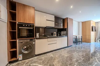 a kitchen with a washer and a dishwasher at appartement Confort & modernité au centre de Marrakech in Marrakech