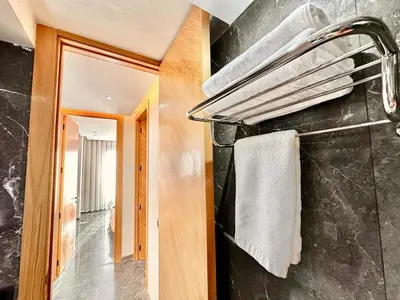 a bathroom with a towel rack on a wall at Cozy and Spacious Apartment, Free Parking in Marrakech