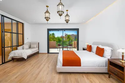 a bedroom with a bed and a couch at Villa Anzar Refined Oasis wChef and Emerald Hammam in El Rhechat