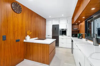 a kitchen with a large clock on the wall at Villa Anzar Refined Oasis wChef and Emerald Hammam in El Rhechat