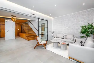 a living room with a couch and a table at Villa Anzar Refined Oasis wChef and Emerald Hammam in El Rhechat