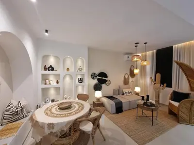 a living room with a bed and a table and chairs at Bohemian & Moroccan Apartment Close to Airport & Medina in Marrakech