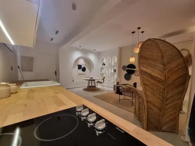 a kitchen with a wooden counter top and a living room at Bohemian & Moroccan Apartment Close to Airport & Medina in Marrakech