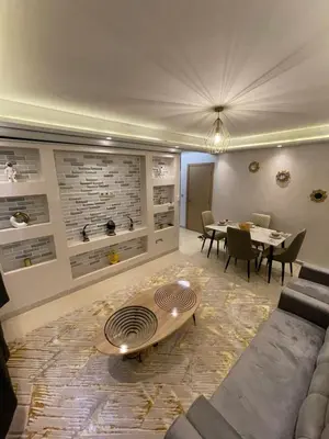 a living room with a couch and a table at Vivez le rêve dans un appartement F4 moderne in Marrakech