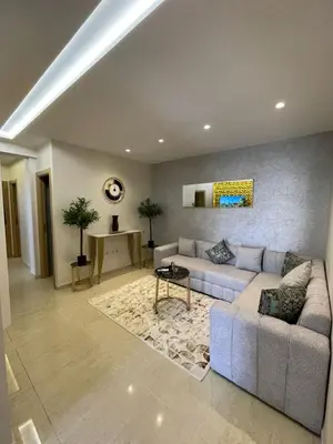 a living room with a couch and a table at Vivez le rêve dans un appartement F4 moderne in Marrakech