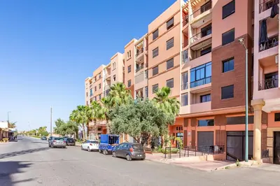 an empty street in front of a tall building at Apartment with swimming pool in Marrakech
