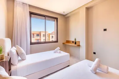 a bedroom with a bed and a window at Apartment with swimming pool in Marrakech