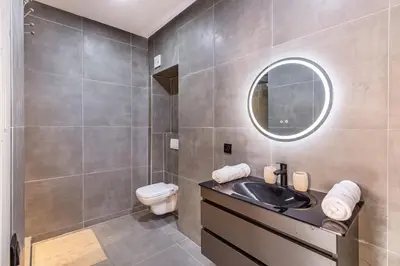 a bathroom with a sink and a toilet and a mirror at 2 chambres dans la ville rouge in Douar Bellouk