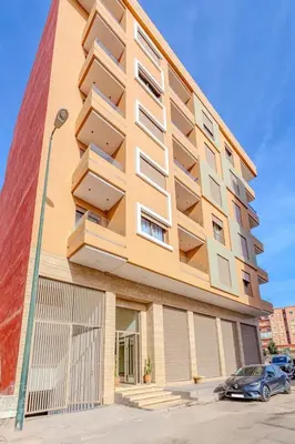 a building with balconies on the side of it at Escapade intime en ville rouge in Marrakech