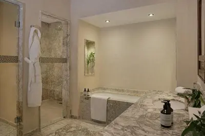 a bathroom with a shower and a tub and a sink at Villa Yali in Marrakech