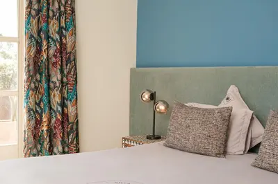 a bedroom with a bed with a curtain and a window at Villa Monica in Marrakech