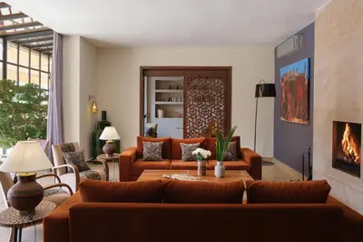 a living room with a couch and a fireplace at Villa Monica in Marrakech